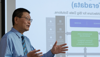 Man presenting data flowchart on screen.