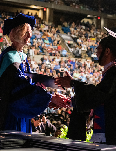 Chancellor Gooch shaking grads hand