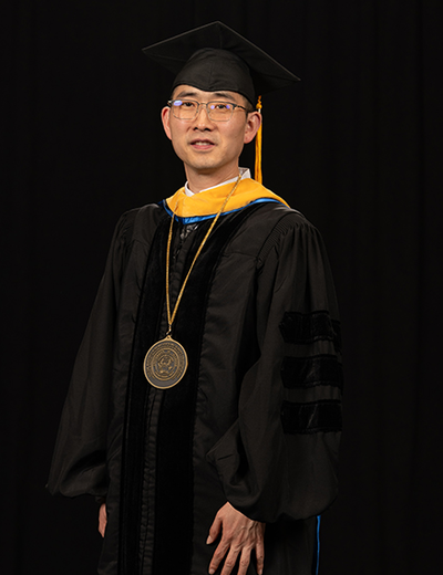 Yanhui Guo stands in regalia during his Ceremony of Investiture.