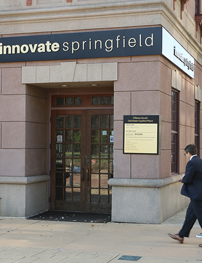Two people walk past the entrance of Innovate Springfield, a UIS innovation hub in downtown Springfield, Illinois.