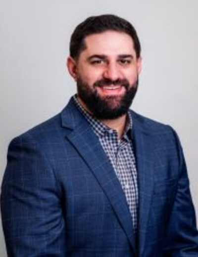 headshot of Adam Unes