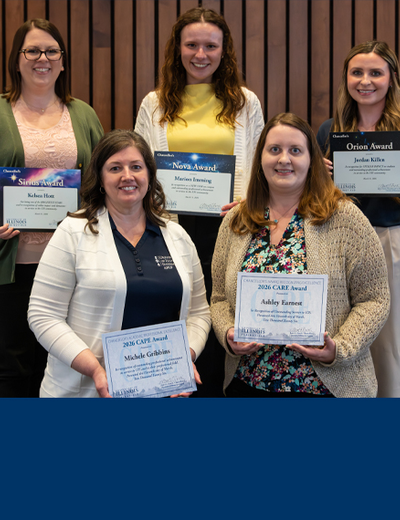 Five women smiling and holding certificates.