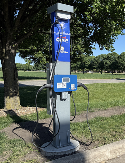 Electric vehicle charging station in a park setting.