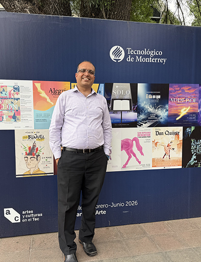 Man standing in front of a poster display at Tecnológico de Monterrey.