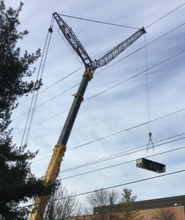 Crane hoisting equipment onto the roof of HSB