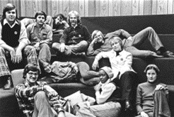 A group of students from the 1970's laying on a staircase