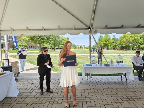 Angela McComas receiving award