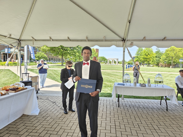 Frank Opia receiving award