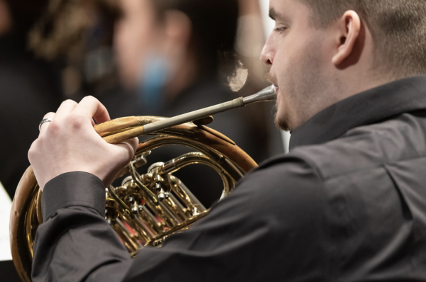 Musician playing a French horn.