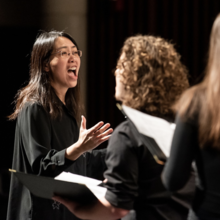 Woman Conducting a Chorus