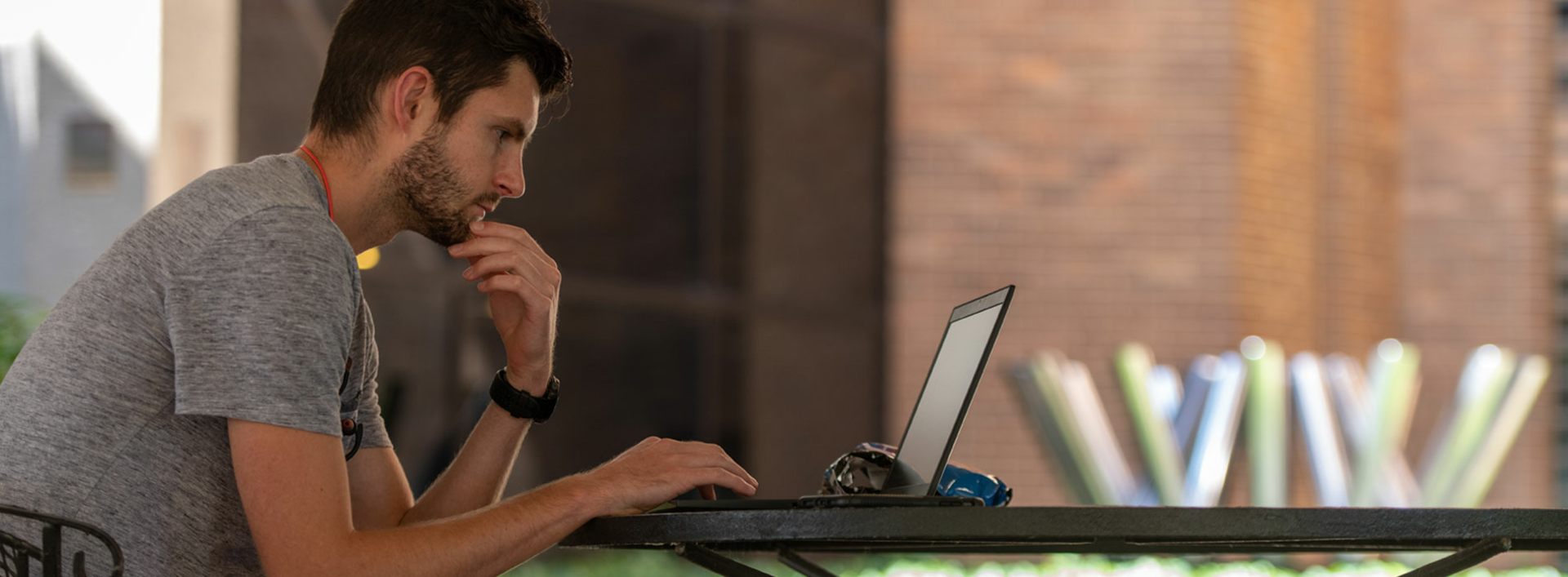 Student studying outside library