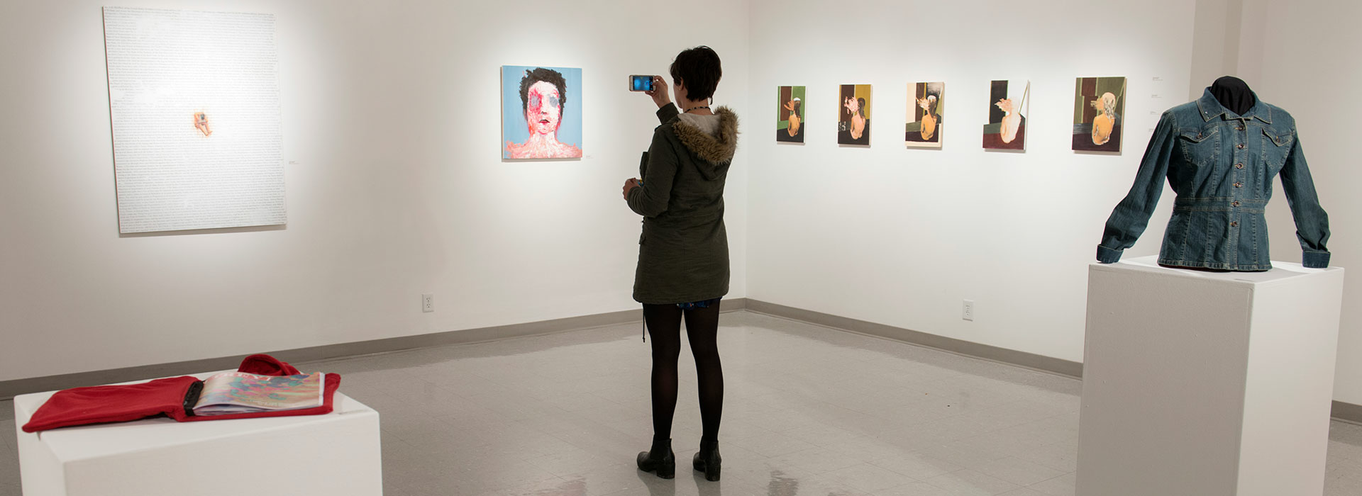 Woman taking a picture in the UIS Visual Arts Gallery