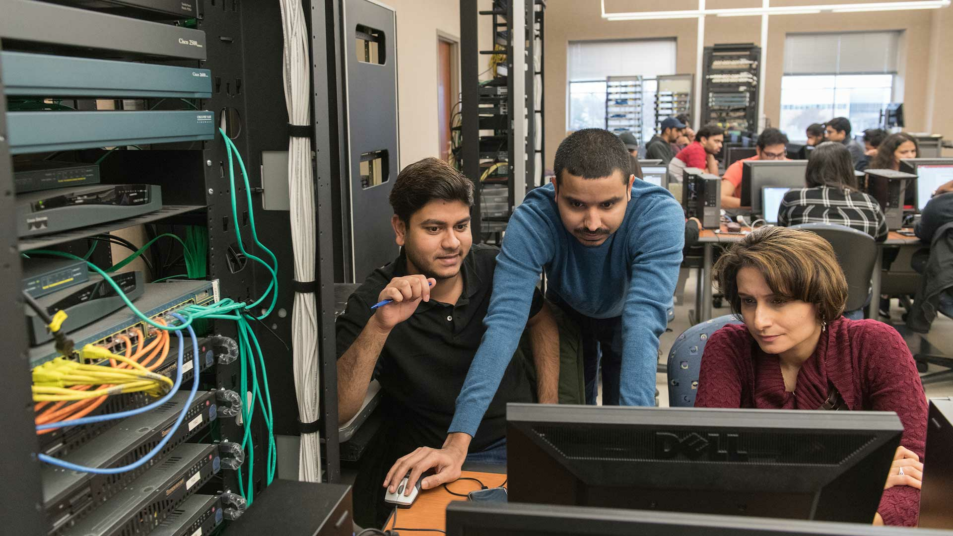 student with professor on computer