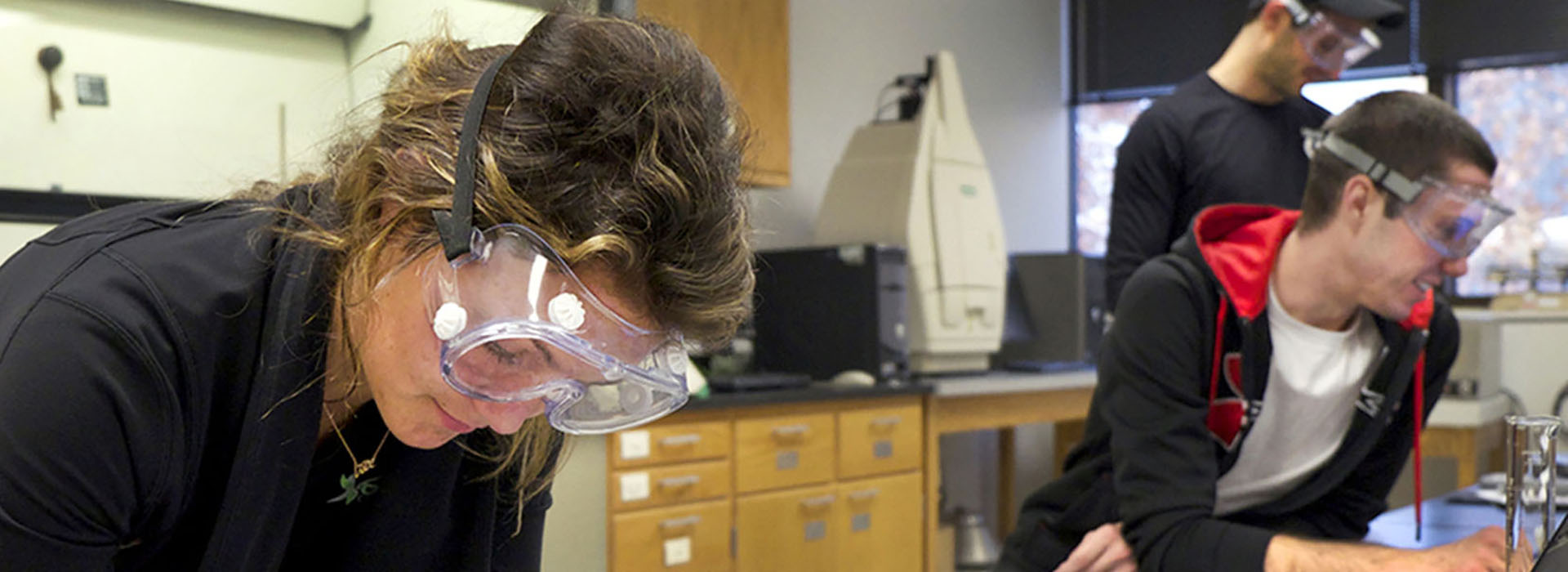 chemistry students wearing safety goggles in a laboratory