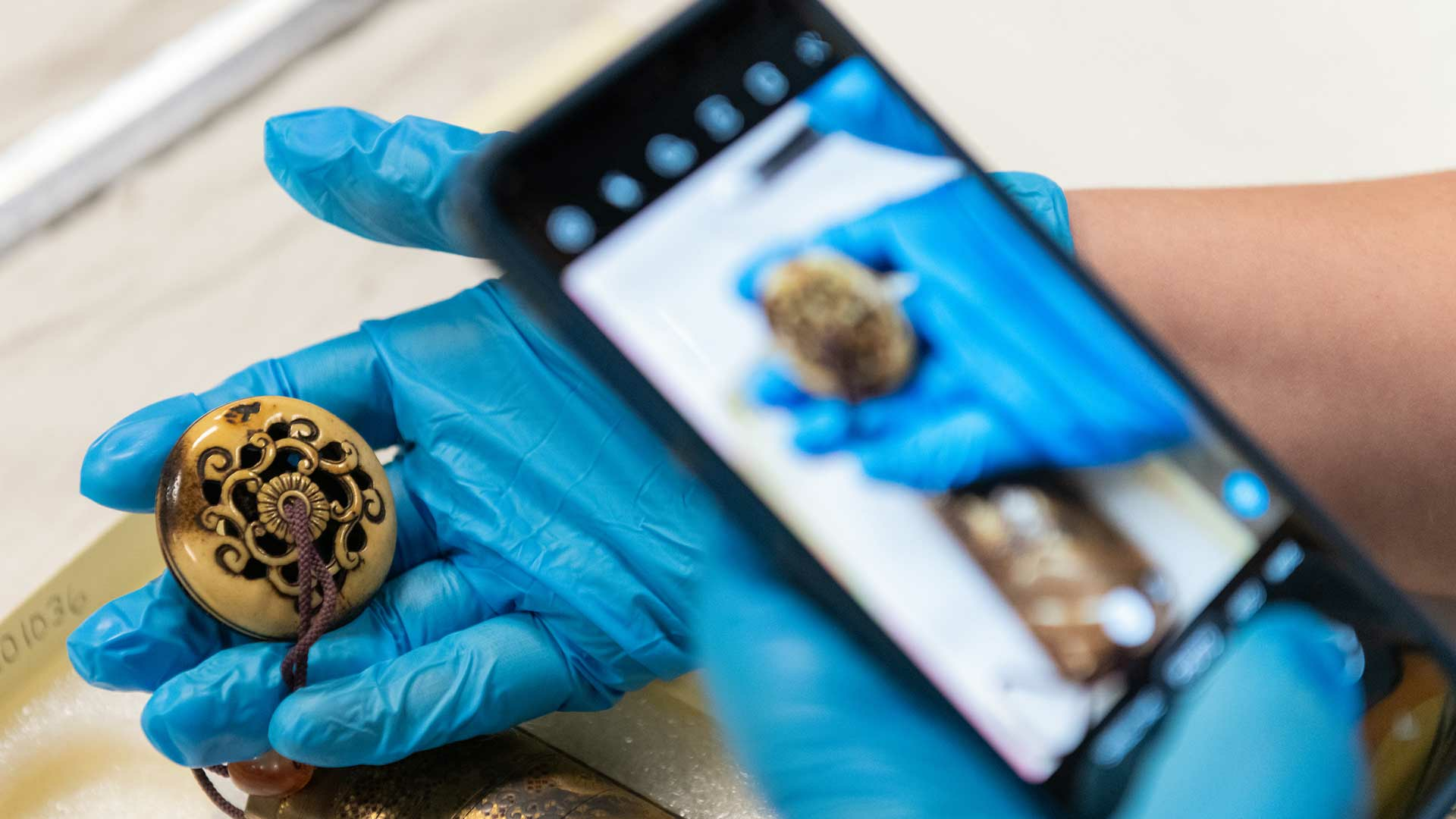 student looking at artifact