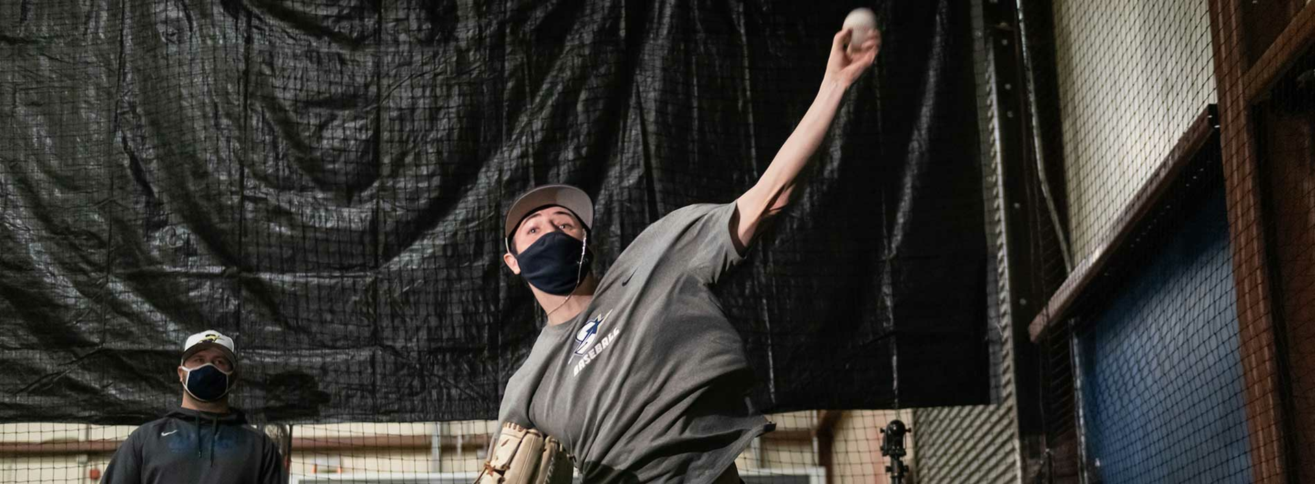 student throwing baseball