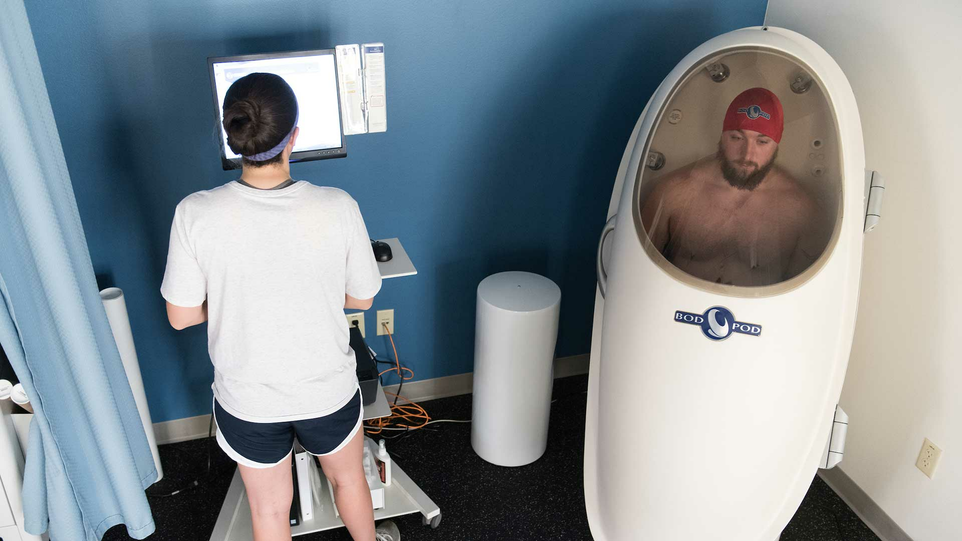 student in the bod pod