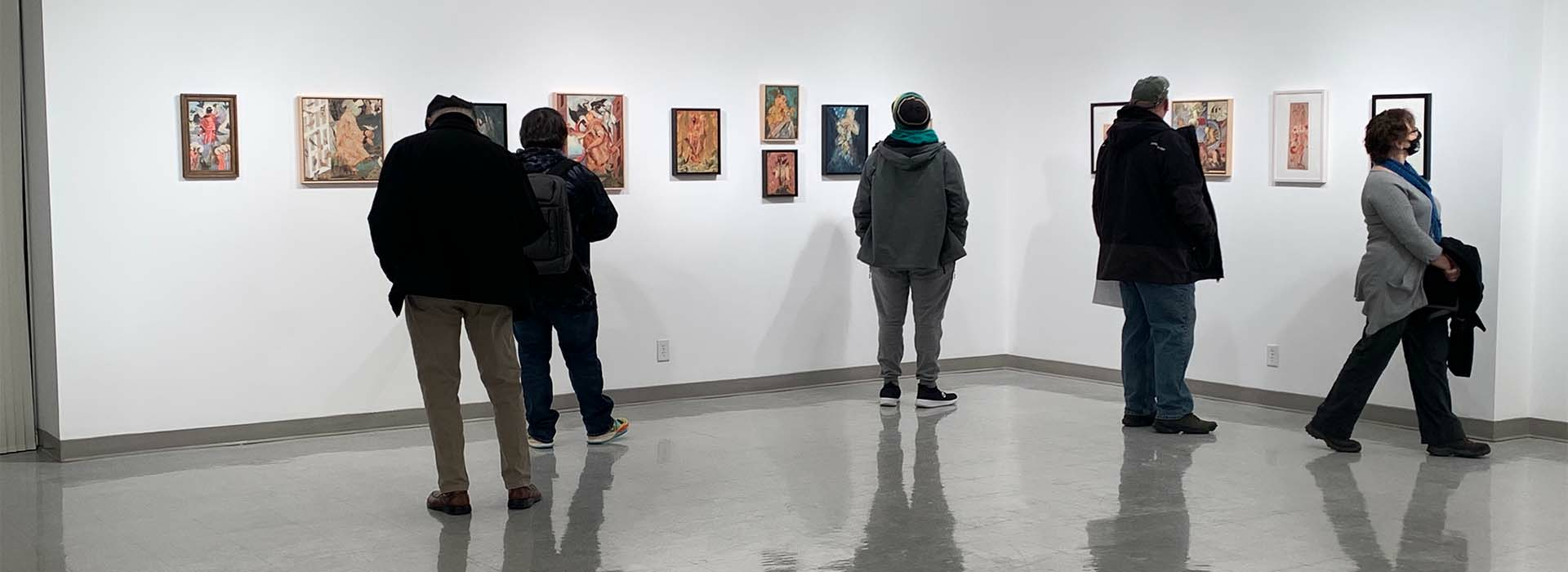 People looking at art in a gallery.