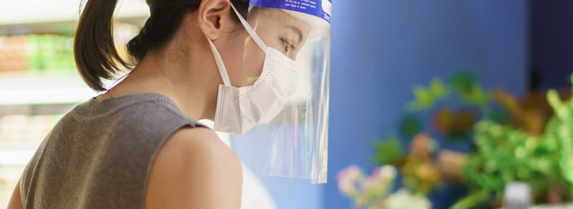 Woman working with mask and face shield