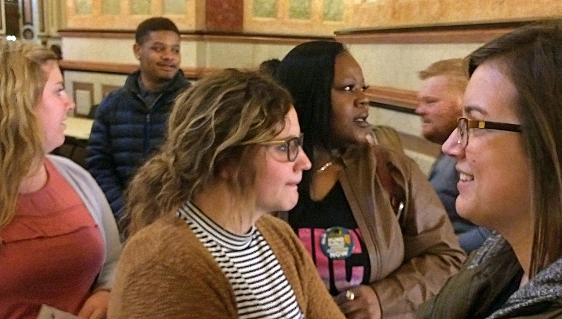 Social Work students stand in a hallway looking around in the capitol building.