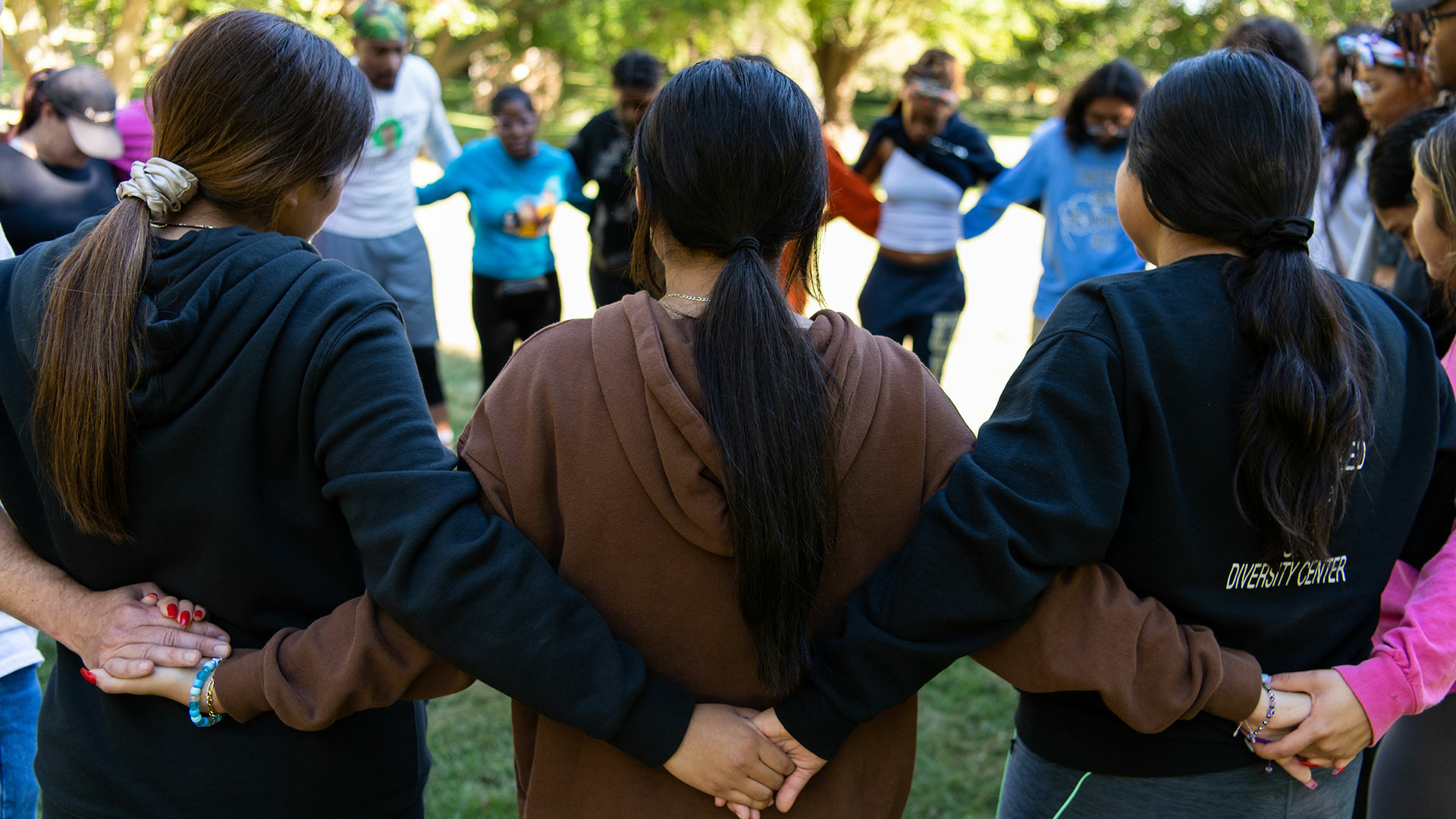 students embracing circle