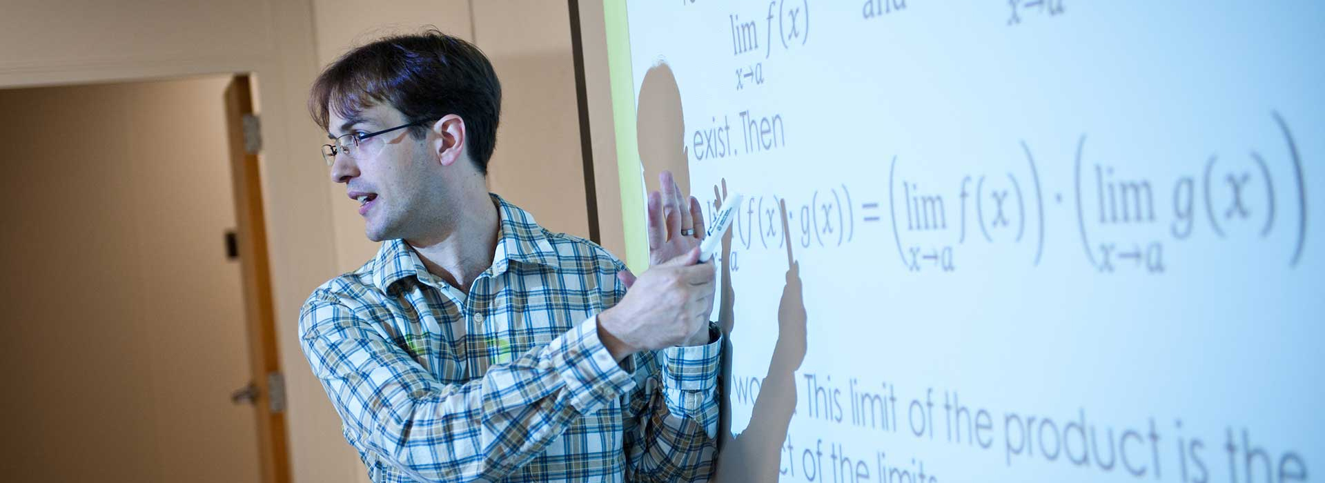 UIS math professor teaching at whiteboard