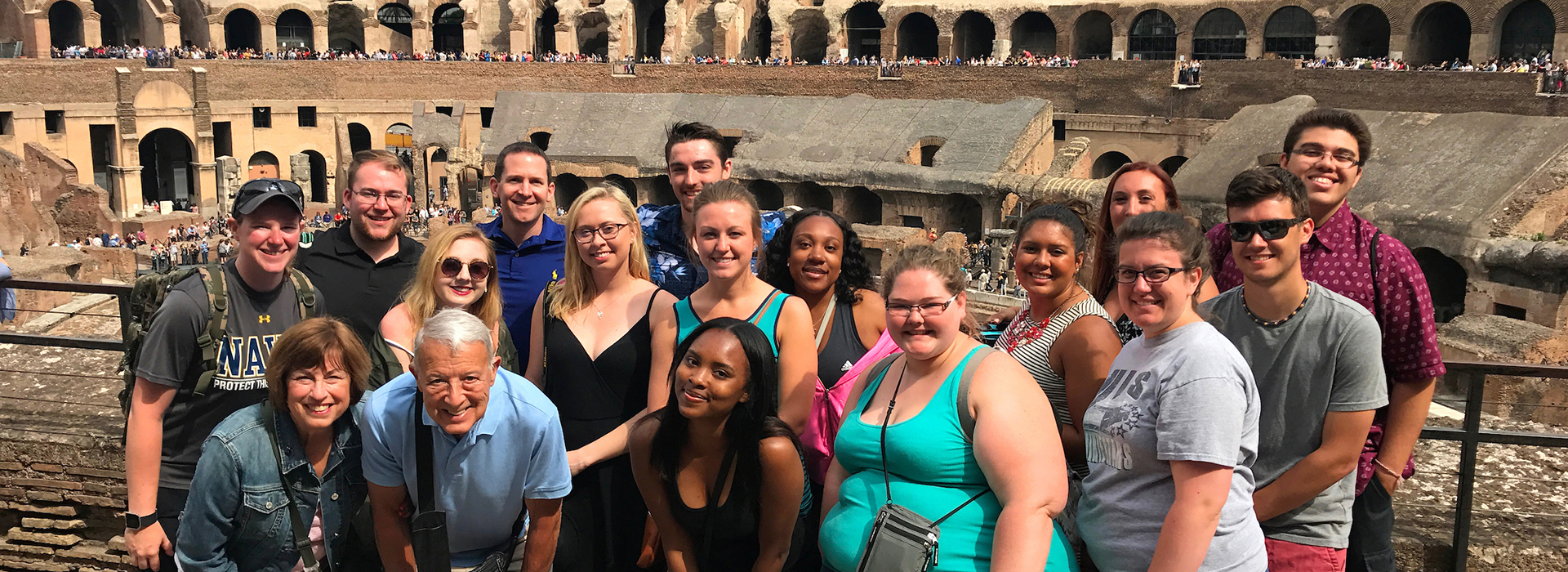 study away students posing in front of Roman colosseum 