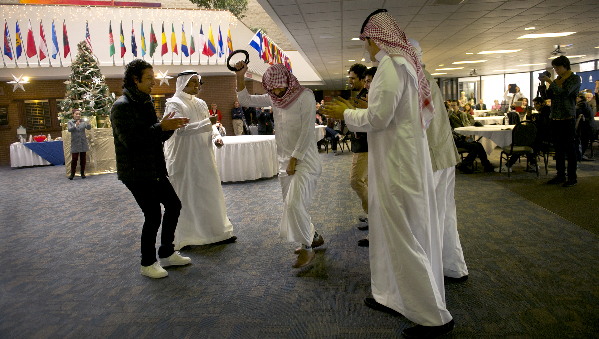 saudi students dancing, flags, holiday tree