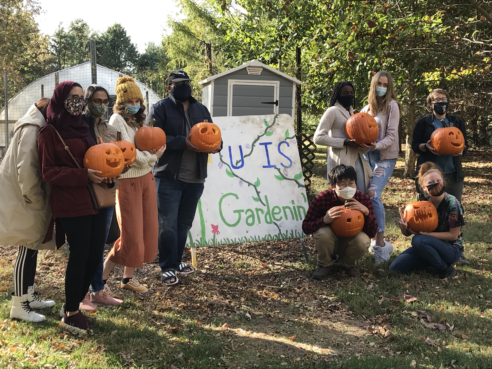 students holding pumpkins 