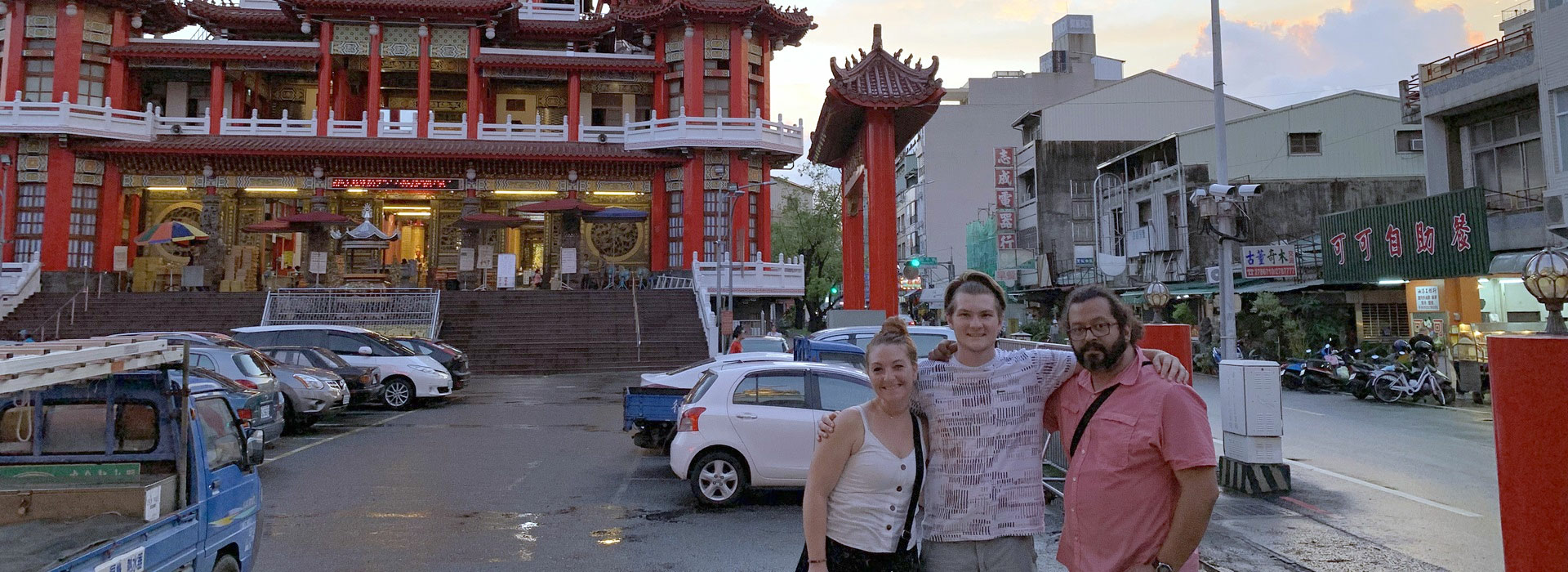 professor and student posing outside traditional building in Taiwan