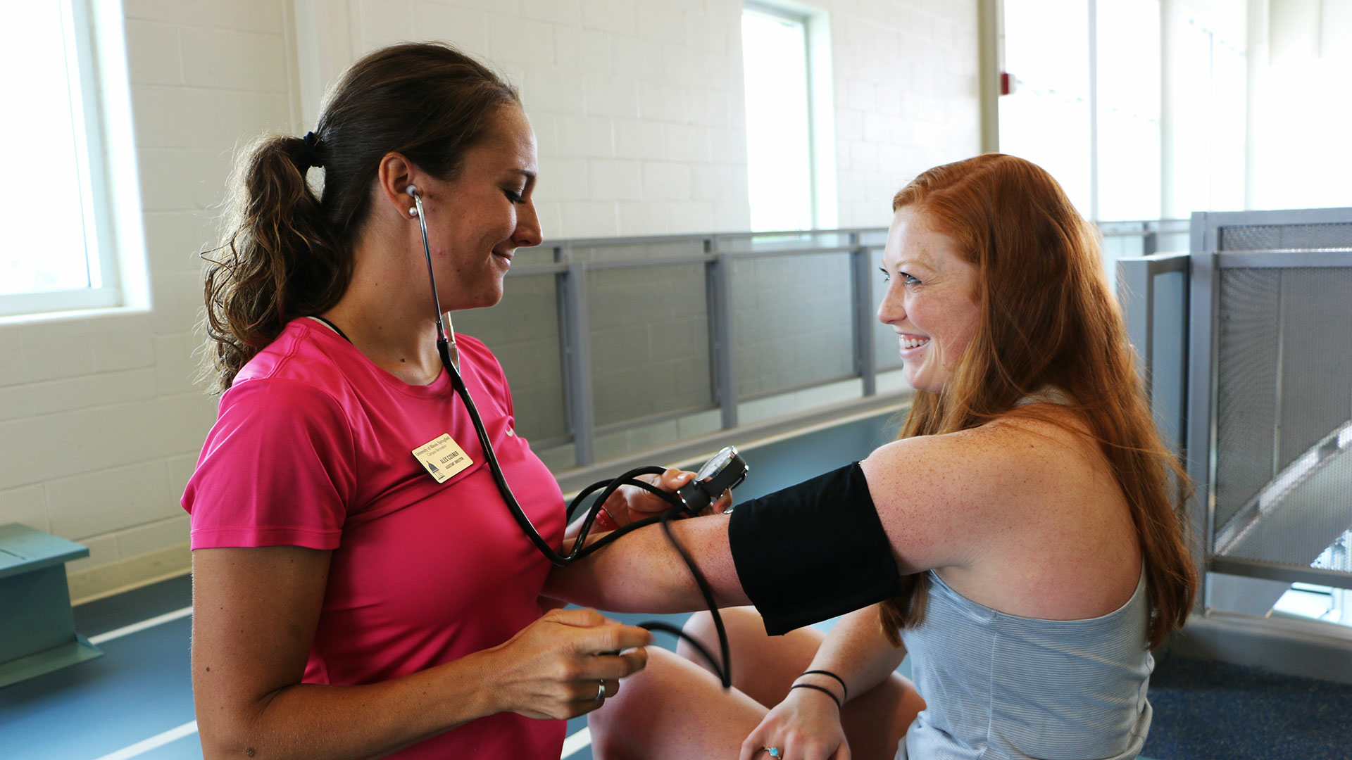 student checking another student's blood pressure