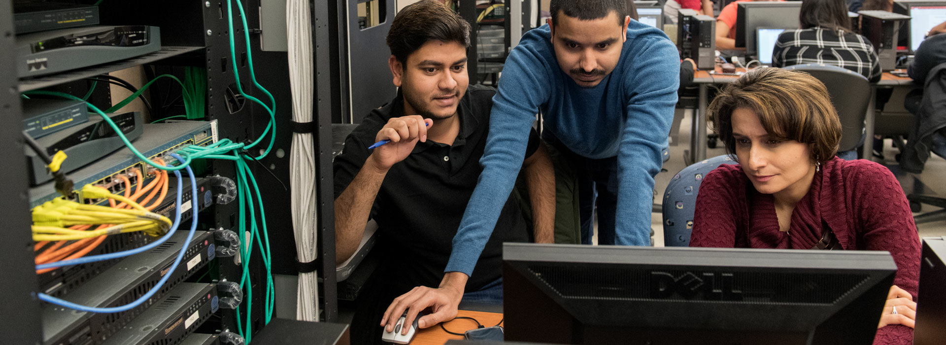 Professor and students at a computer