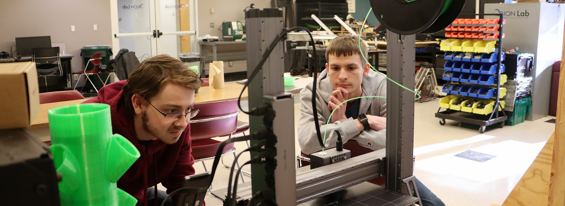 students at a 3D printer in the Orion Lab