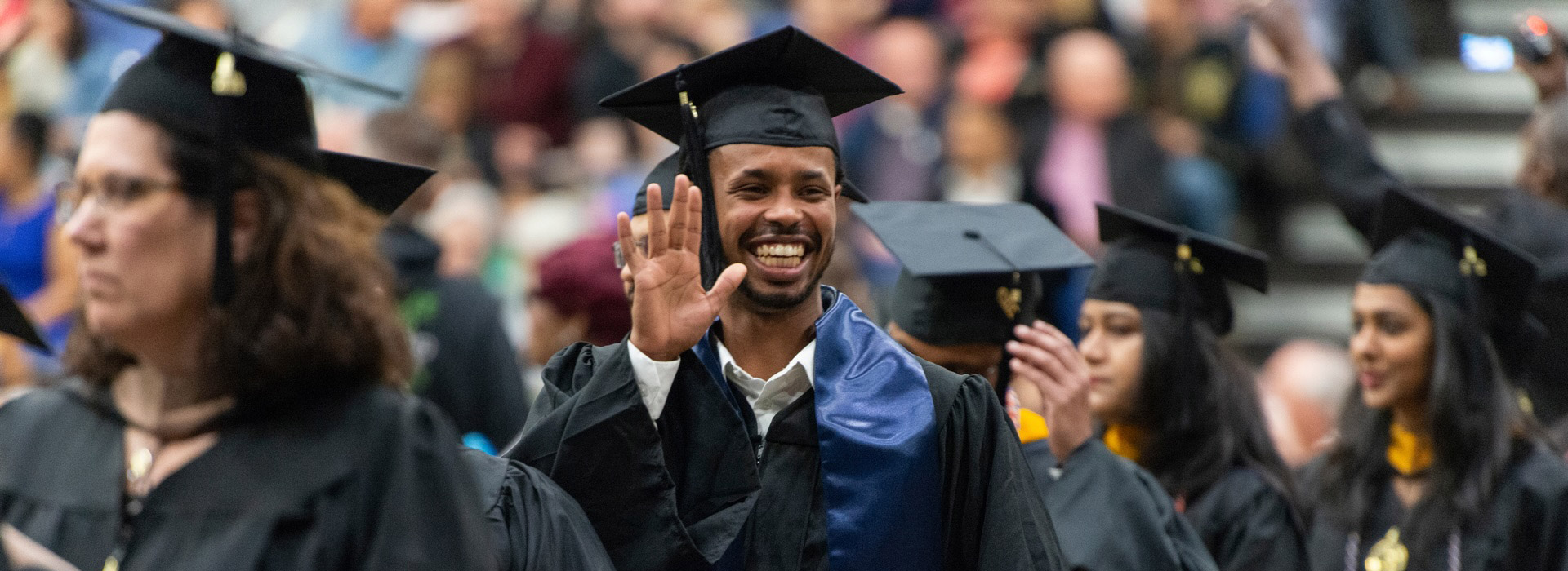 UIS graduates walking at commencement