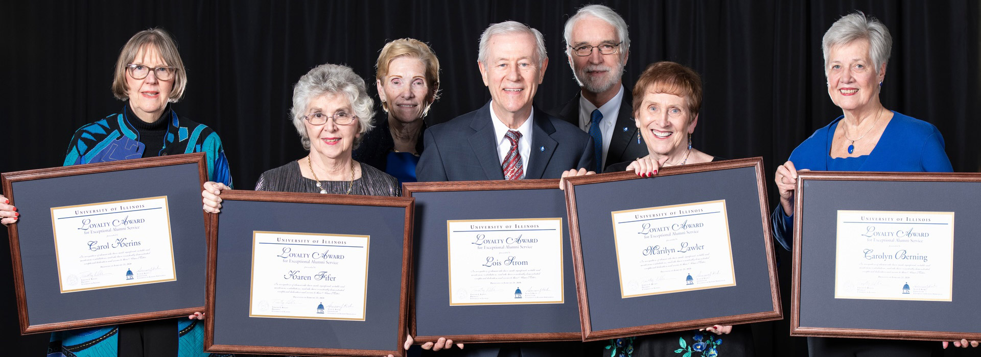 awards recipients posing with their plaques