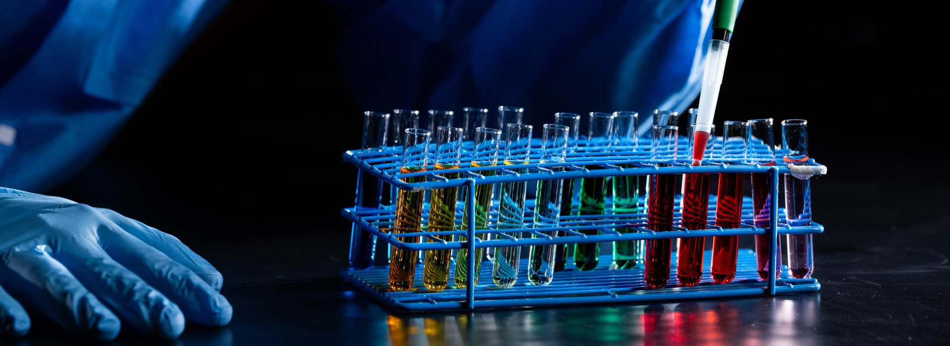 test tubes being filled with colorful liquid