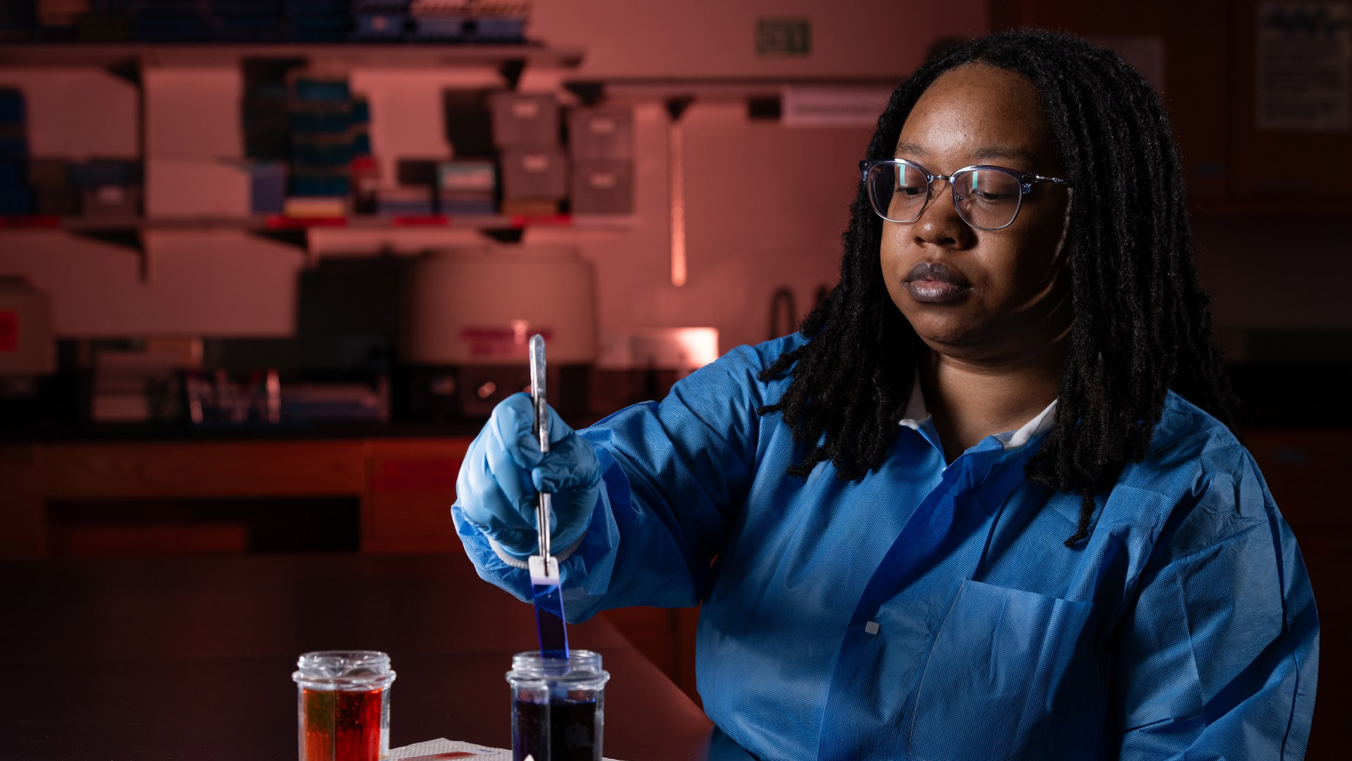 student performing microbiology testing