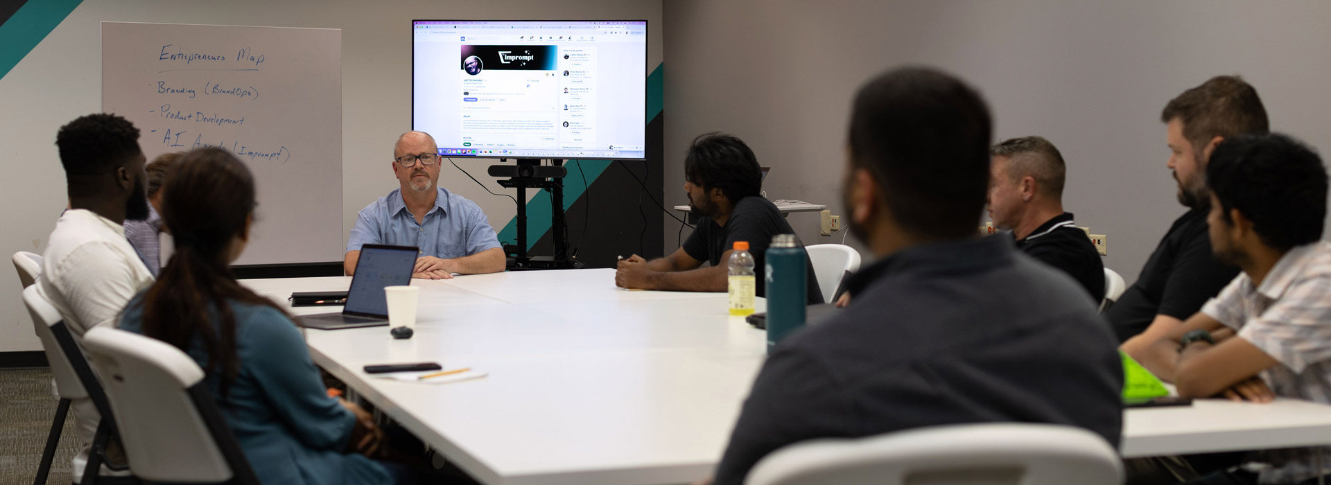 group gathered around a guest speaker at the Innovation Center