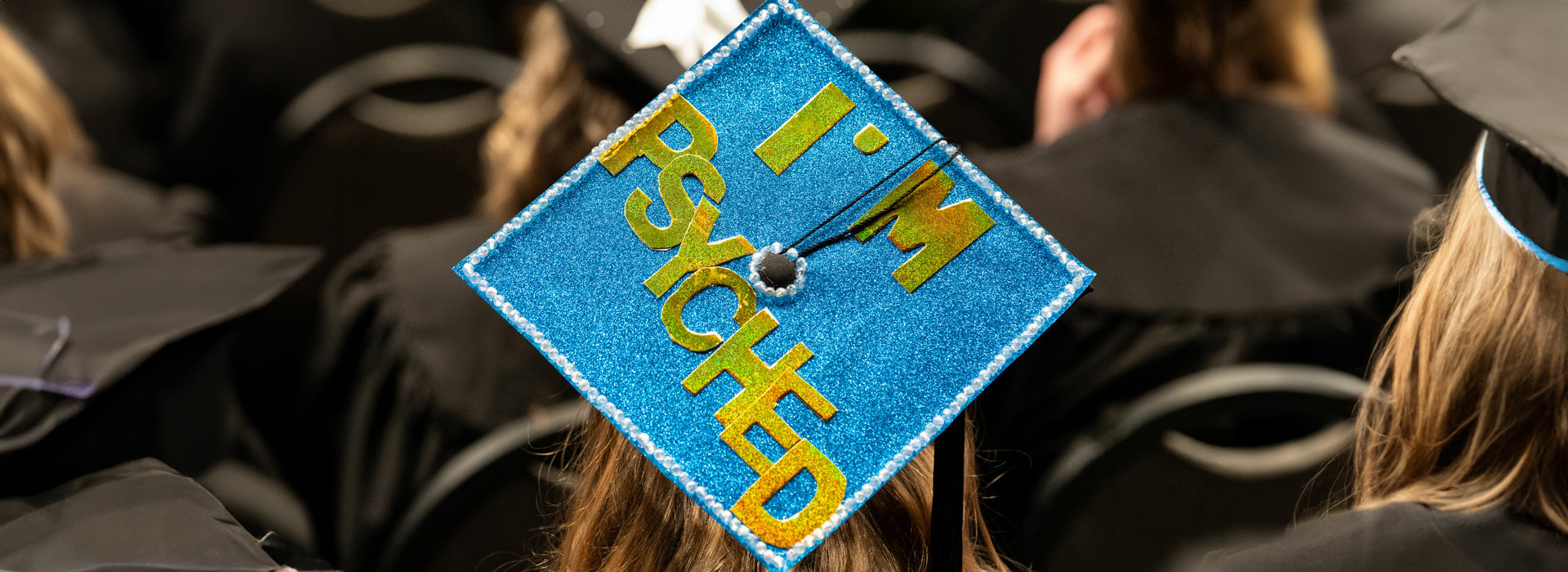 a graduation cap with the words "I'm psyched"