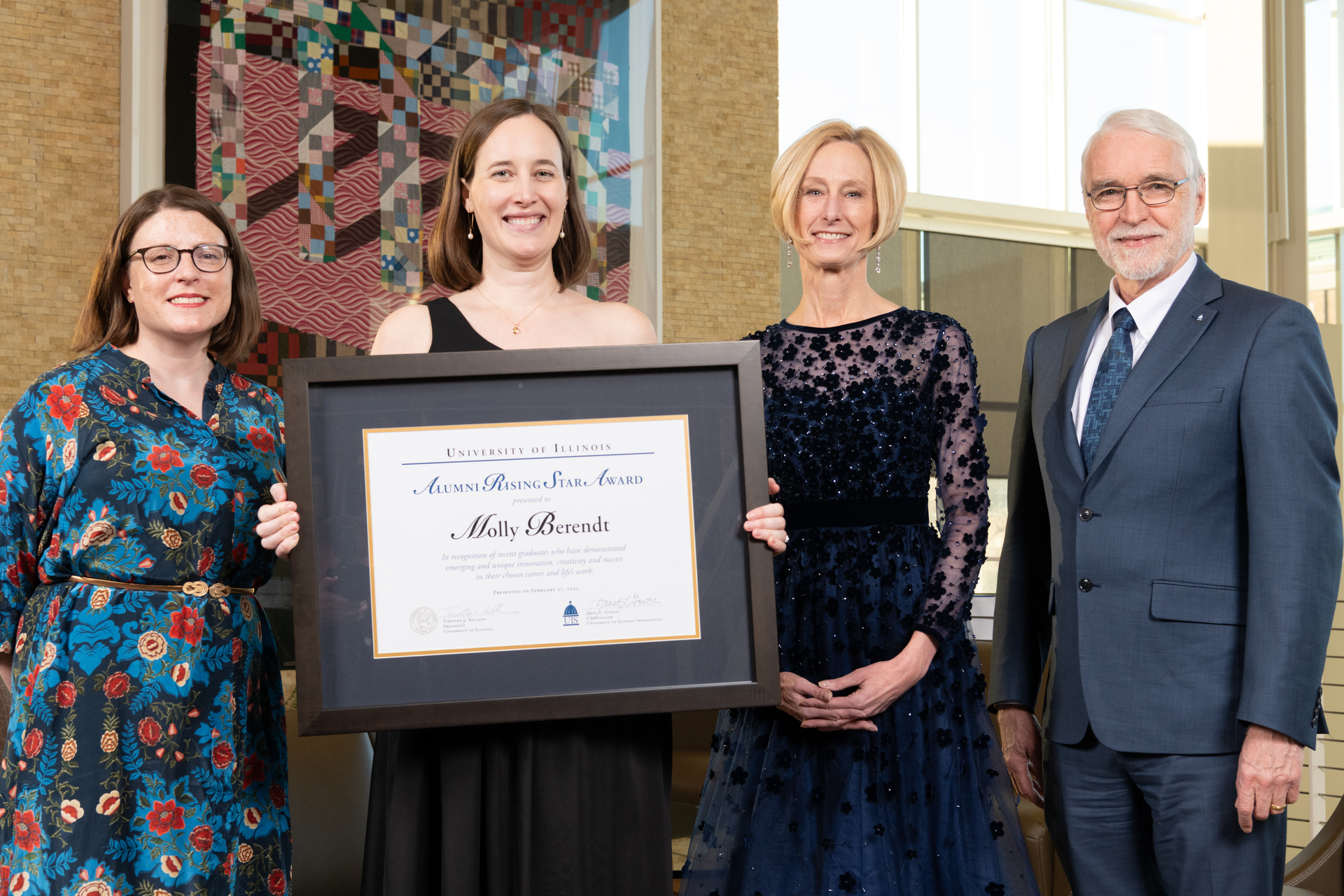 Carly Hawkins, Chancellor Janet Gooch and President Killeen pose with Molly Berendt and her Alumni Rising Star award