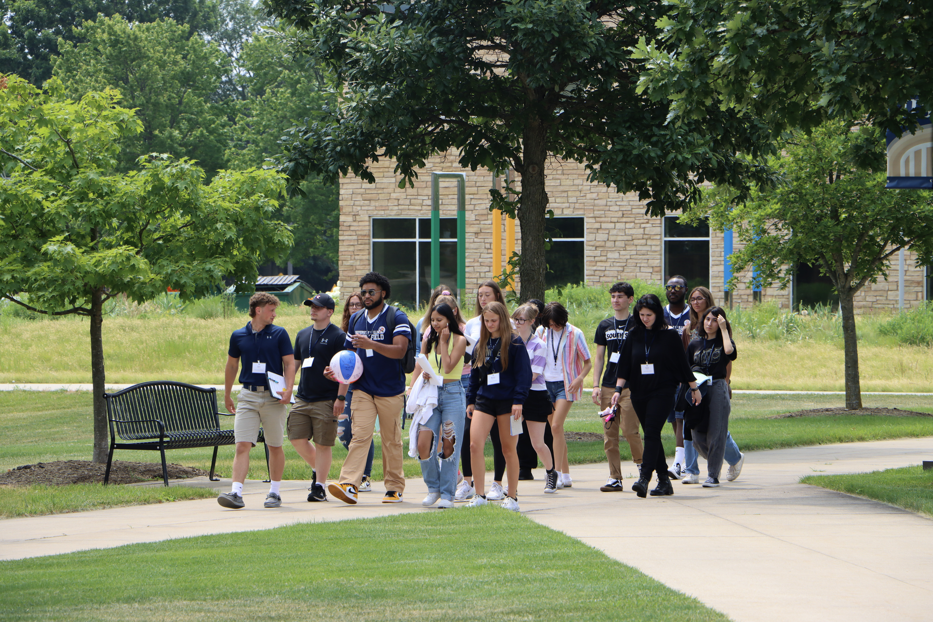 Multiple new students walking on campus together.