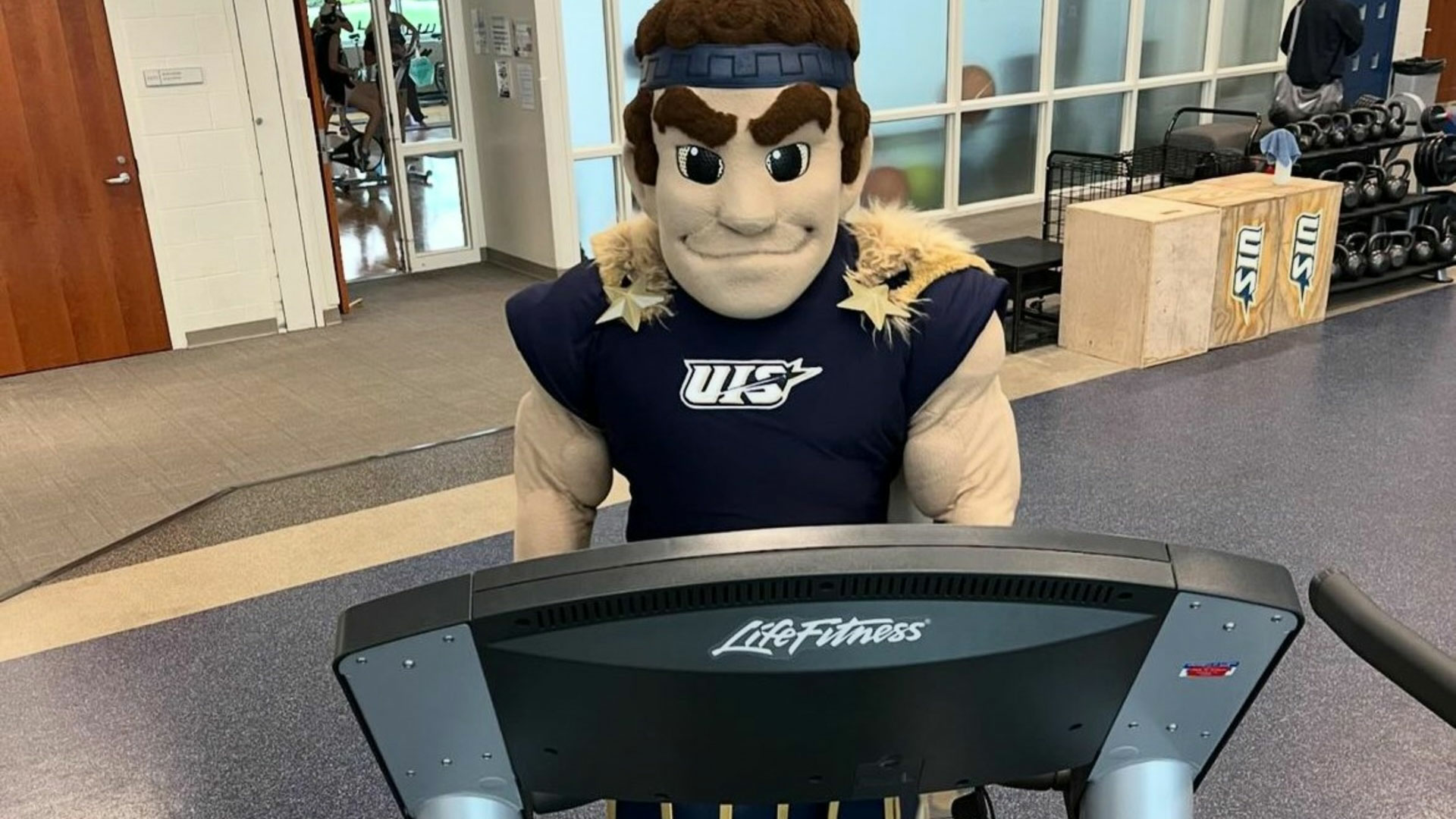 the UIS mascot running on a treadmill