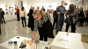 auction attendee bidding on artwork