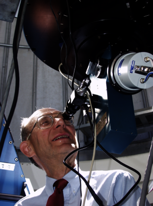 Man looking into a telescope