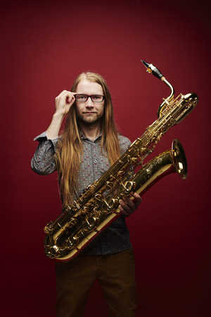 Photograph of a man holding the saxophone