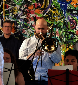 Student Musician performing in a concert holding a trombone.
